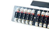 A close up image of a car electric fuse panel showing screws slots and circuit board