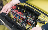 An engineer assembling a car Porsche 911 fuse panel