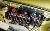 A Porsche 911 front storage area with fuse panel and wires