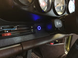 a car dashboard with controls and dials and a blue LED light