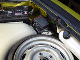 a Porsche 911 front storage area with spare wheel, battery, and air conditioning compressor