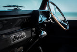 Car interior with steering wheel and dashboard, blurred background