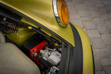 Electric HVAC compressor mounted in the frunk of green Porsche 911 SC