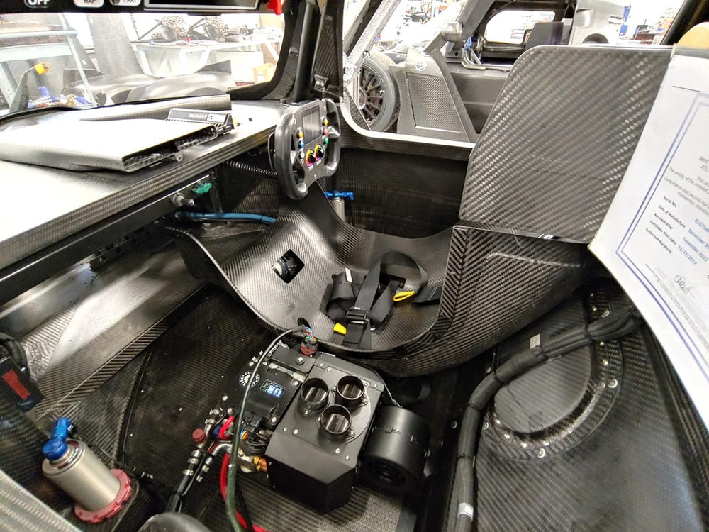  a rang car interior with carbon fibre seat and air conditioning unit in the passenger footwell