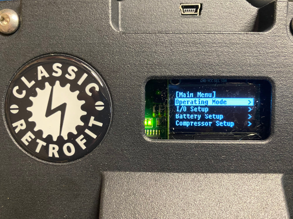 a close up of a digital screen on a smart electric air conditioning compressor showing operating mode
